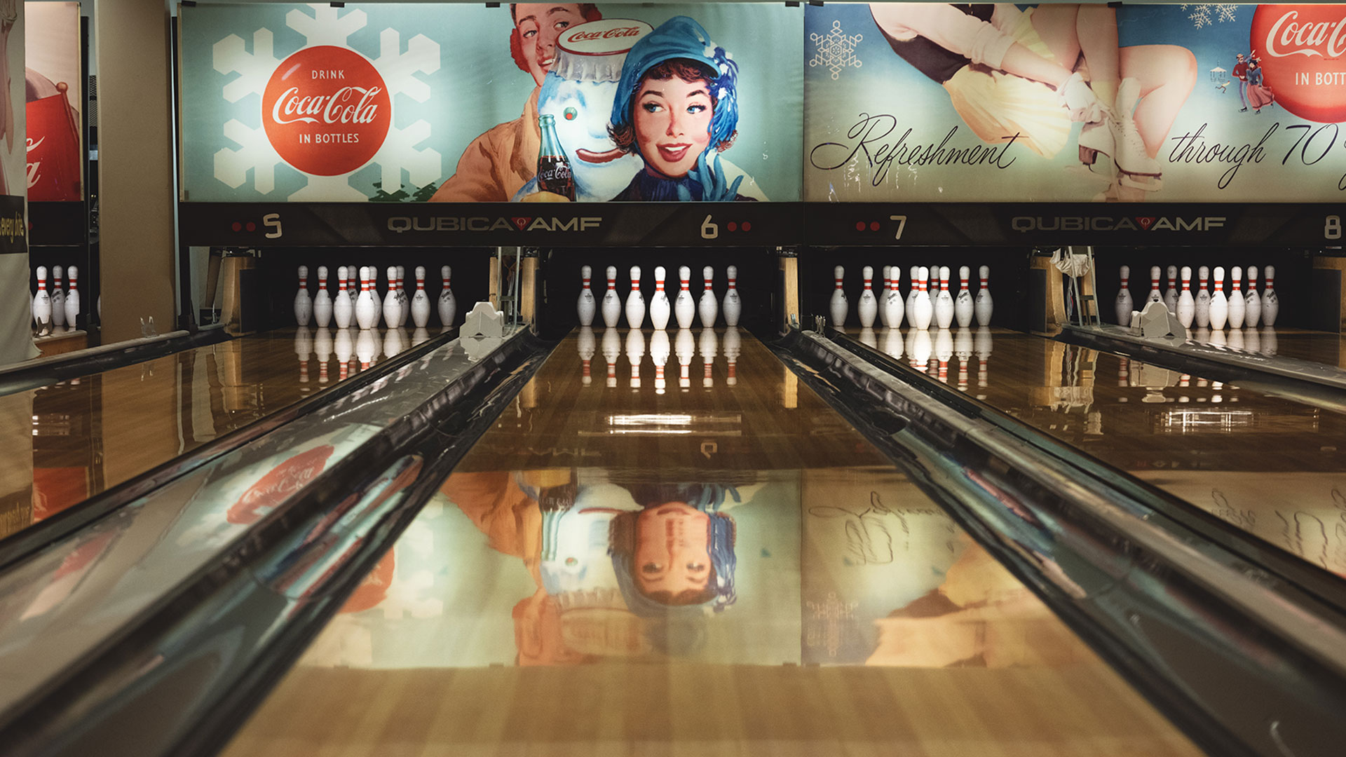 Bowlingbana med Coca-Cola-reklam i retrostil på väggen